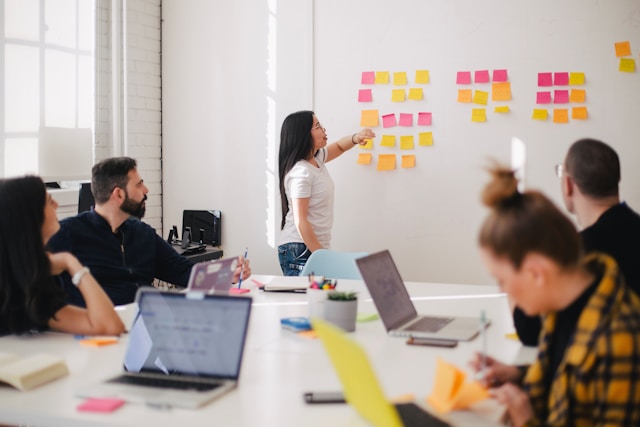 A team of different departments brainstorming during a meeting.